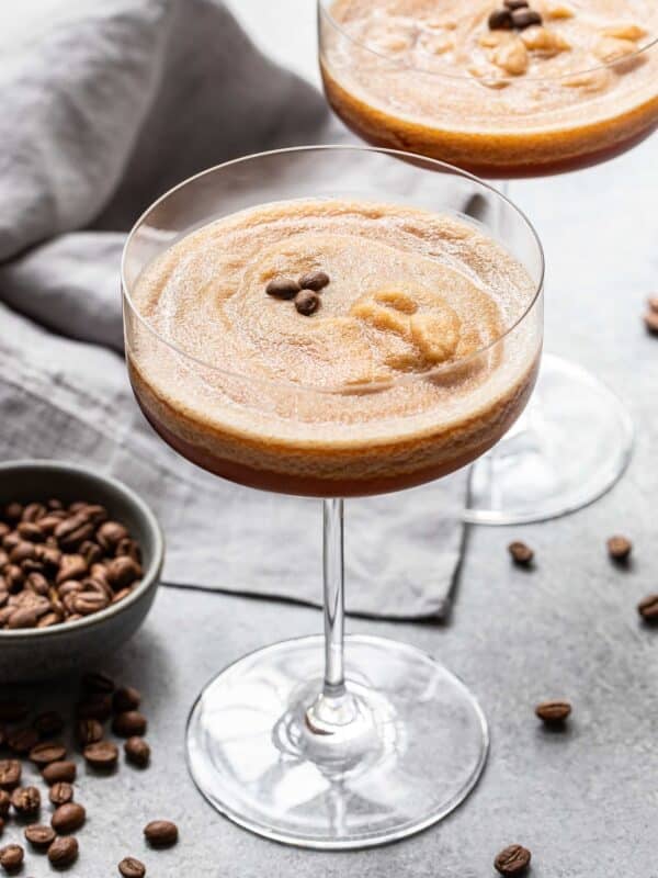 Two frozen espresso martinis in stemmed glasses.