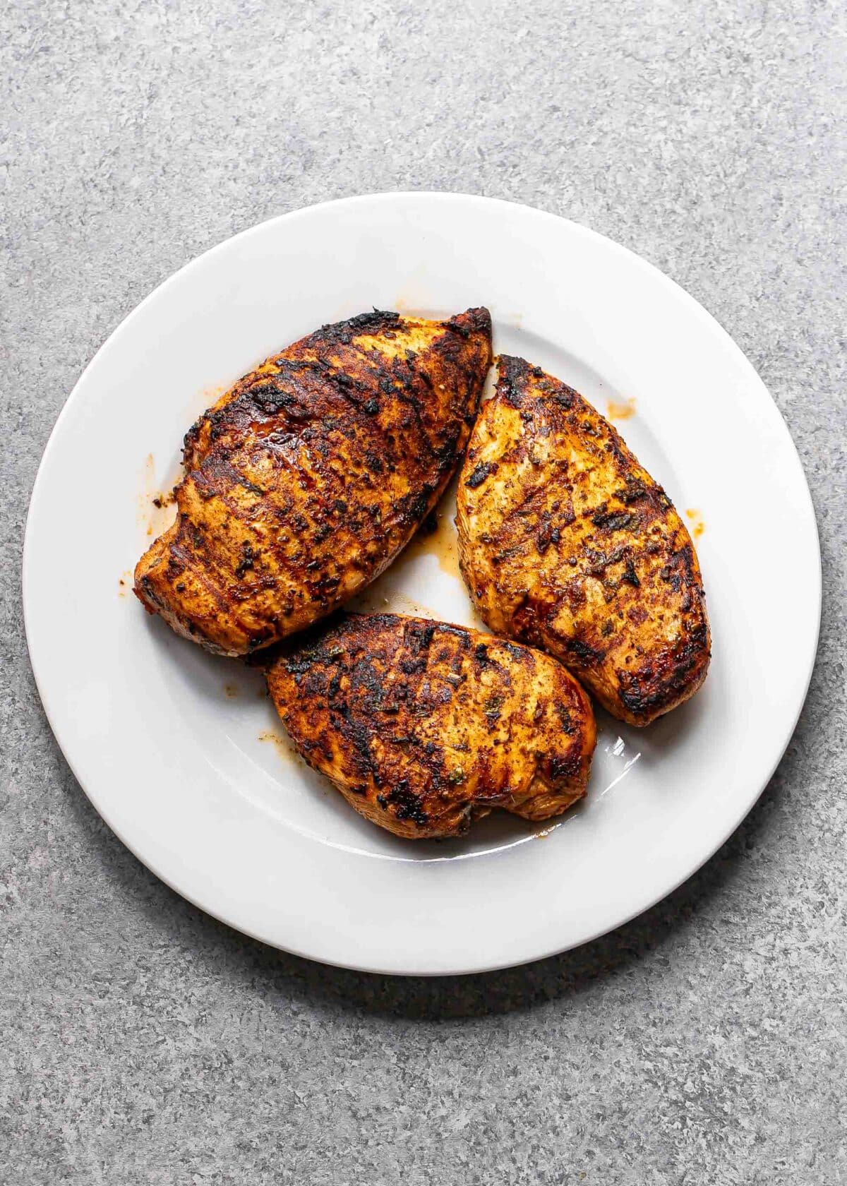 Three southwest chicken breasts on a white plate.