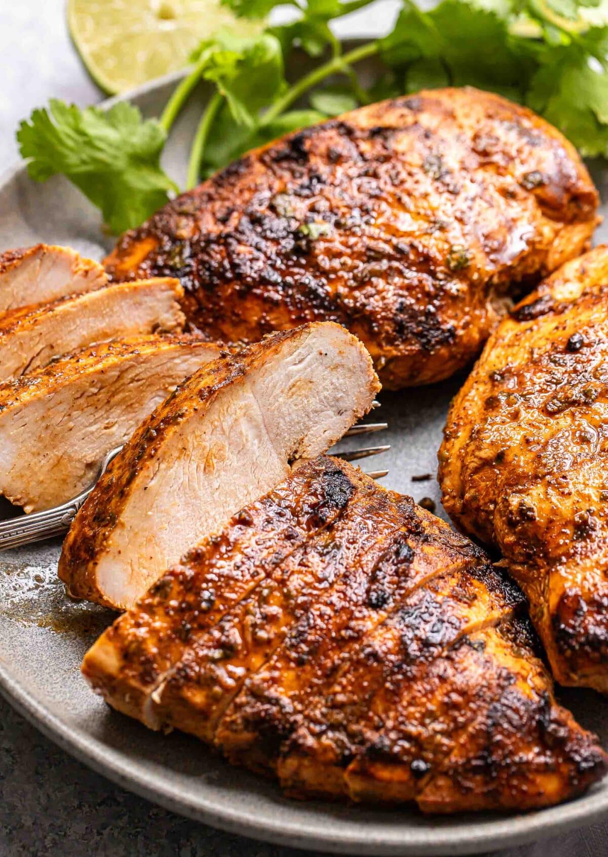 A sliced southwest marinated chicken breast on a gray plate.