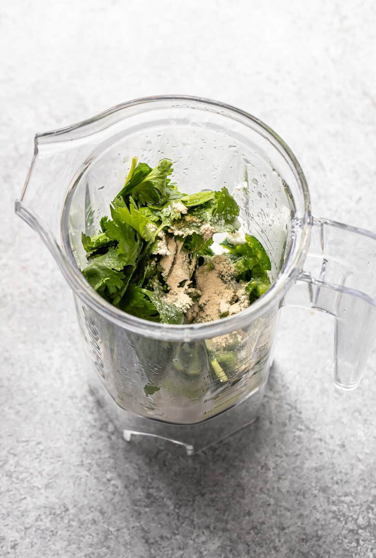 Ingredients for cilantro lime dressing in a blender jar.