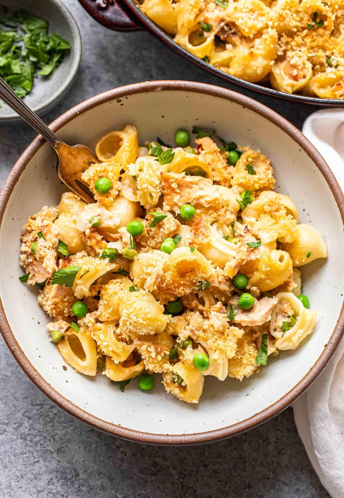 Tuna casserole in a white bowl with a fork.