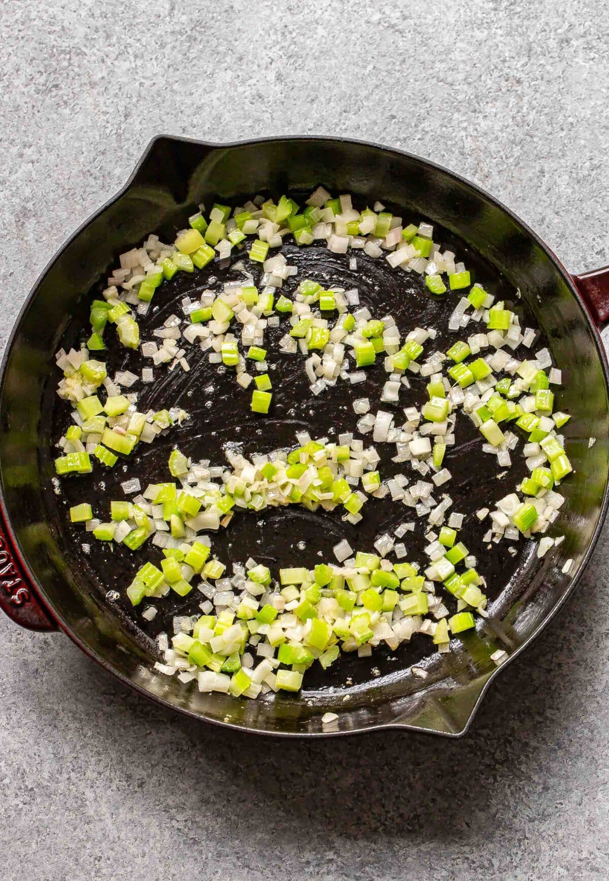 Sauteed celery and onions in a skillet