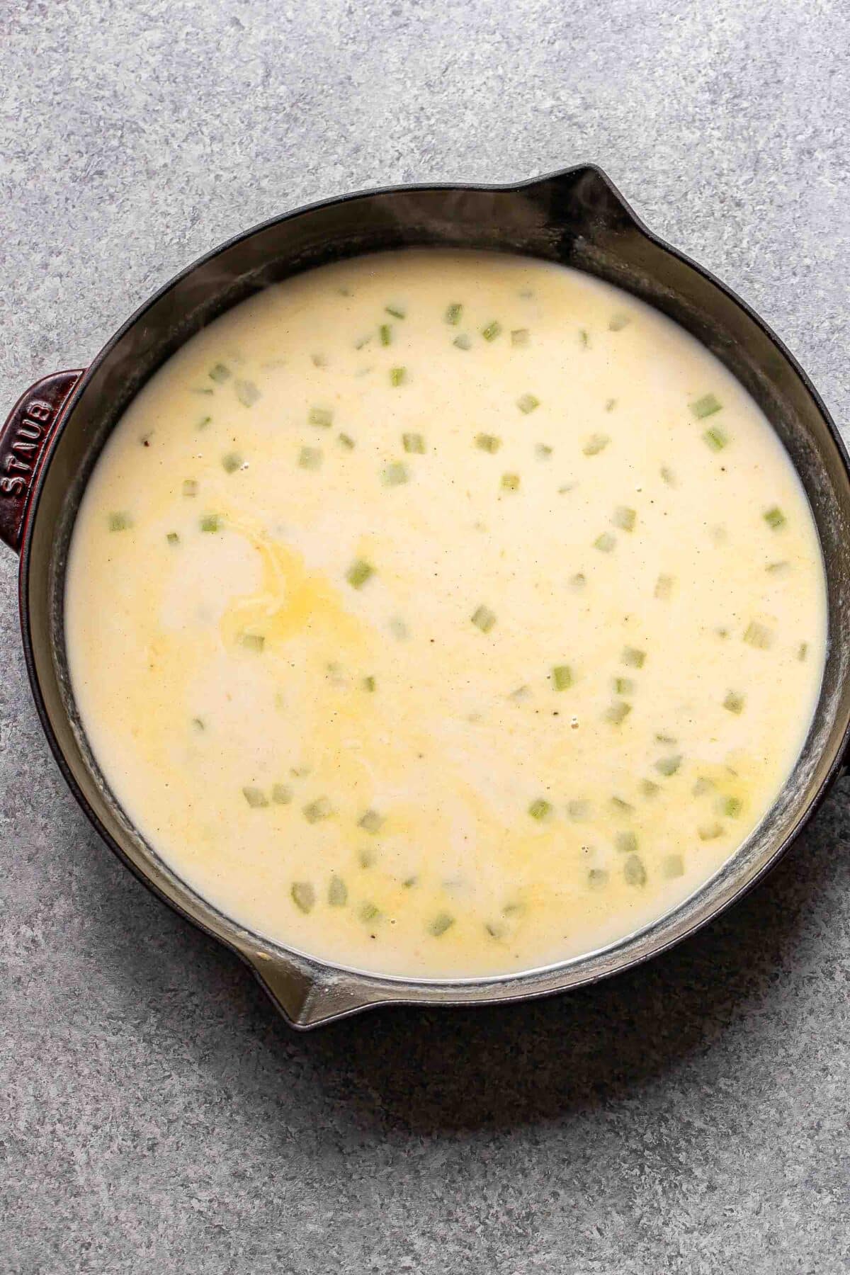 Cream sauce with cheese in a skillet.
