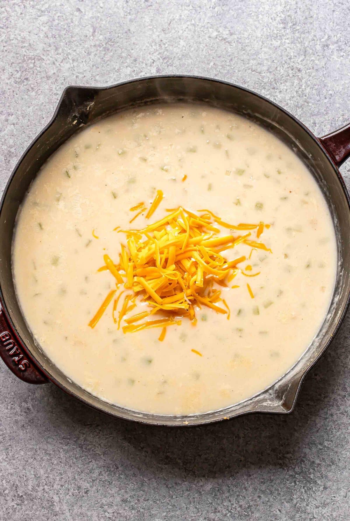 Cream sauce with cheese in a skillet.
