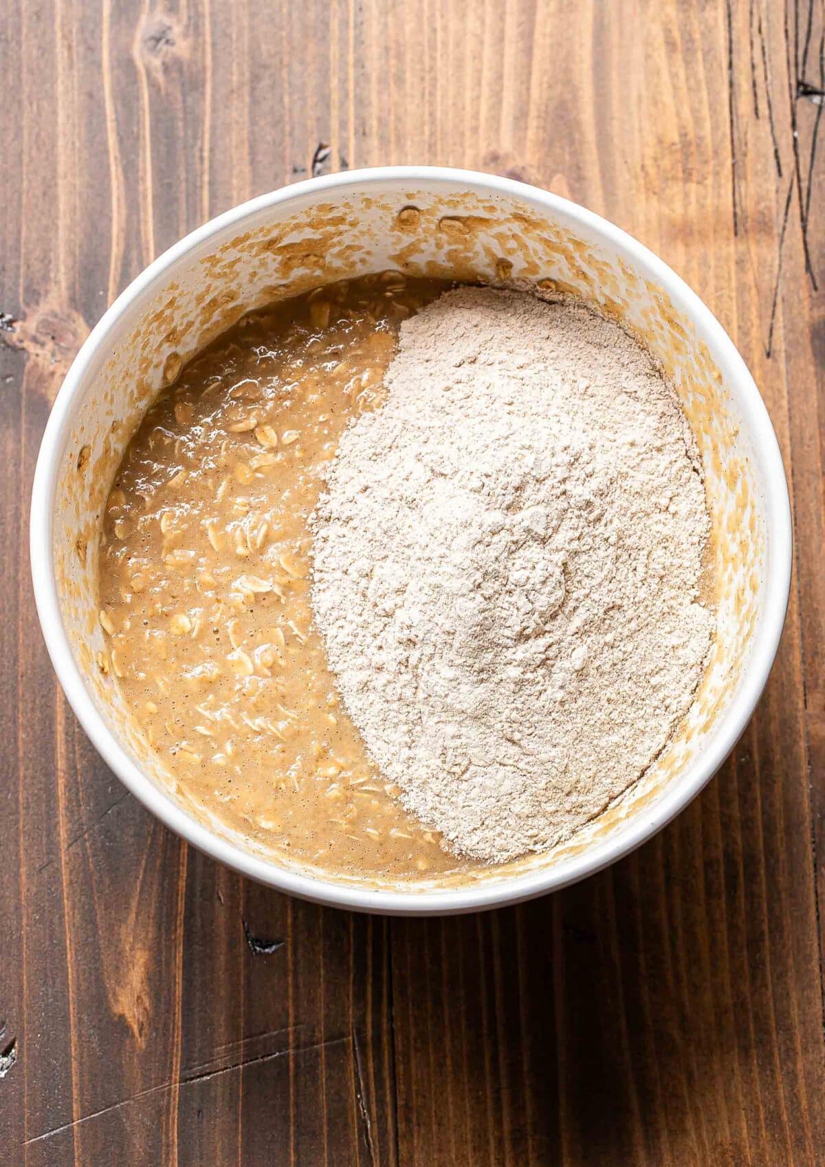 Applesauce muffin batter in a white bowl before being mixed together.