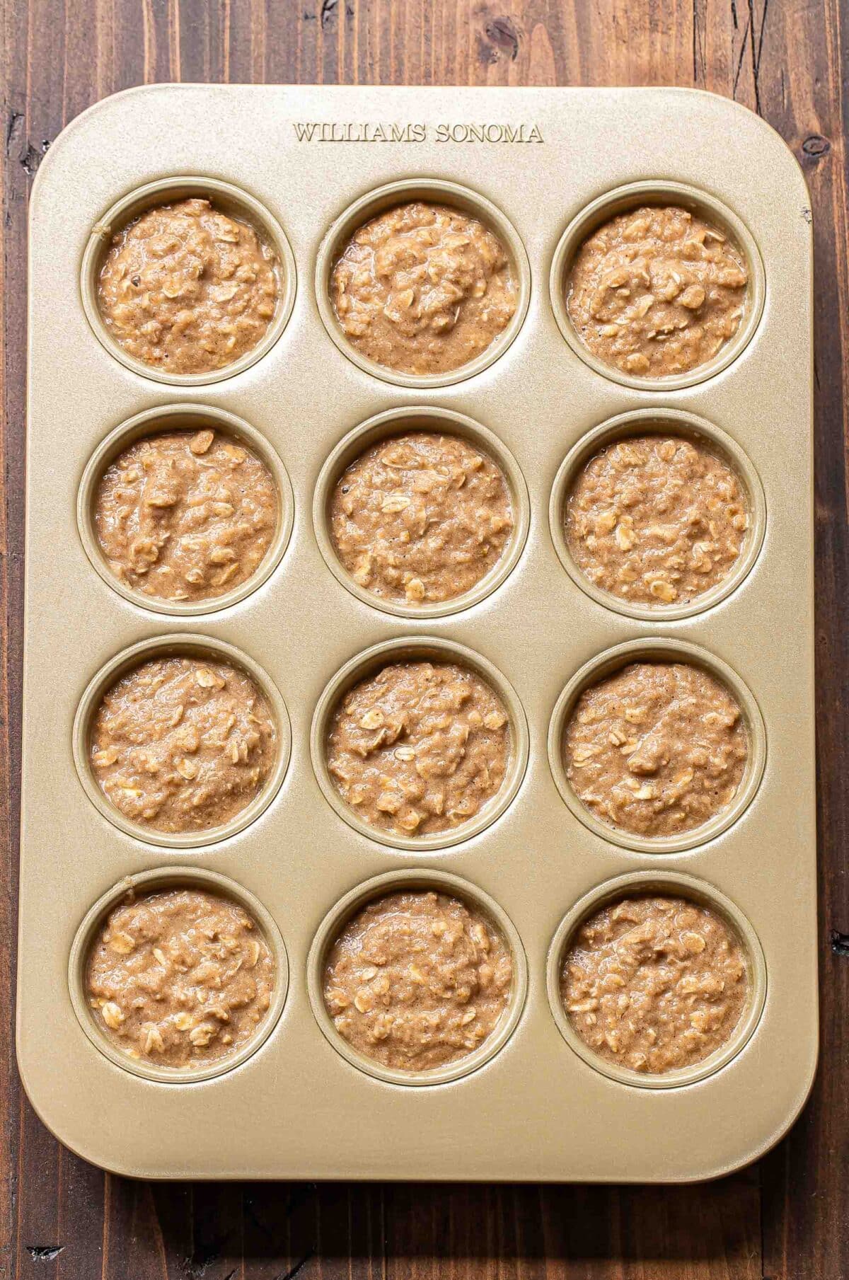 Applesauce muffins in a muffin pan before being baked.