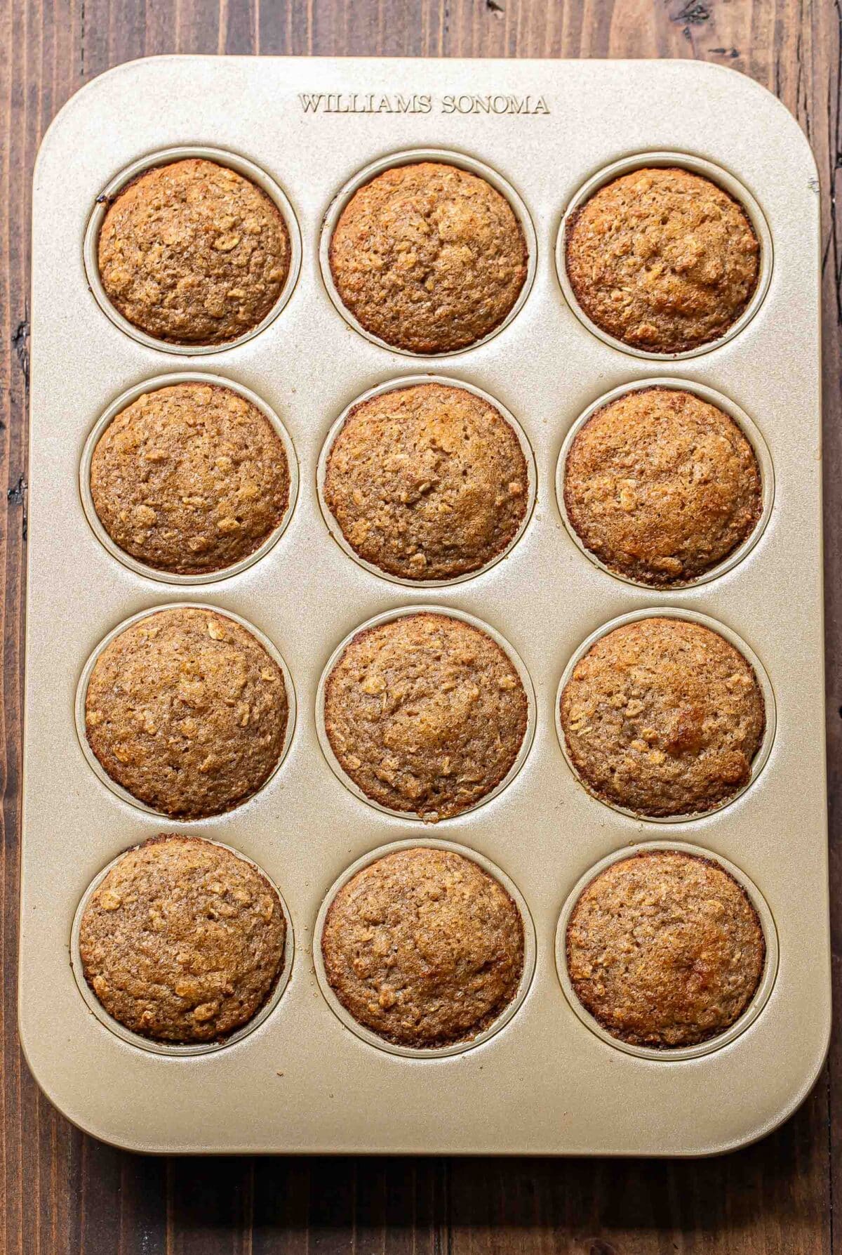 Applesauce muffins in a muffin pan.
