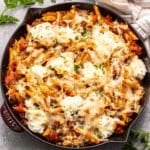 Baked penne with ground beef and ricotta cheese in a skillet.