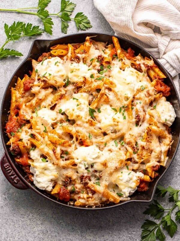 Baked penne with ground beef and ricotta cheese in a skillet.