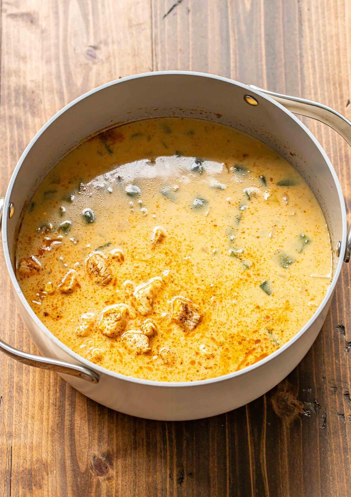 Chicken corn chowder in a pot before it's been cooked down and thickened.