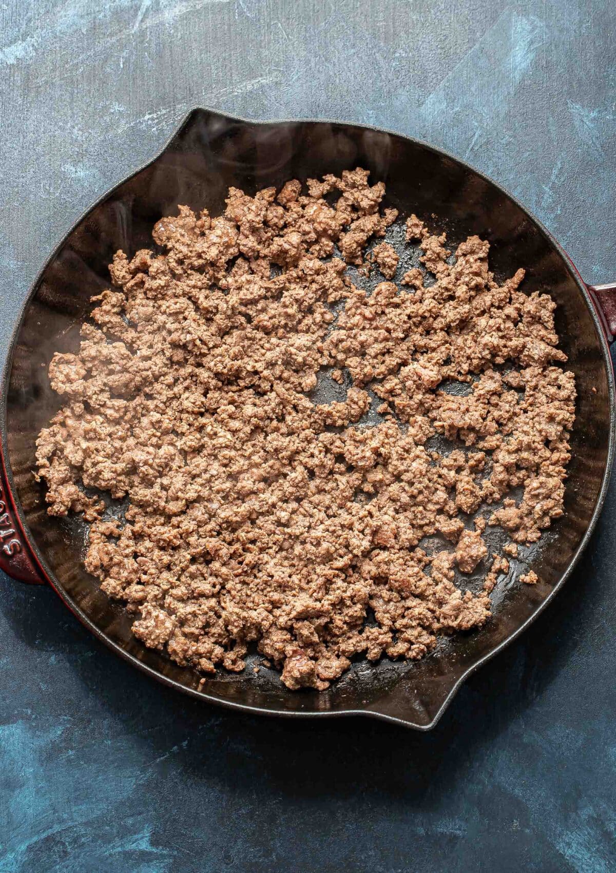 Crumbled ground beef in a skillet.