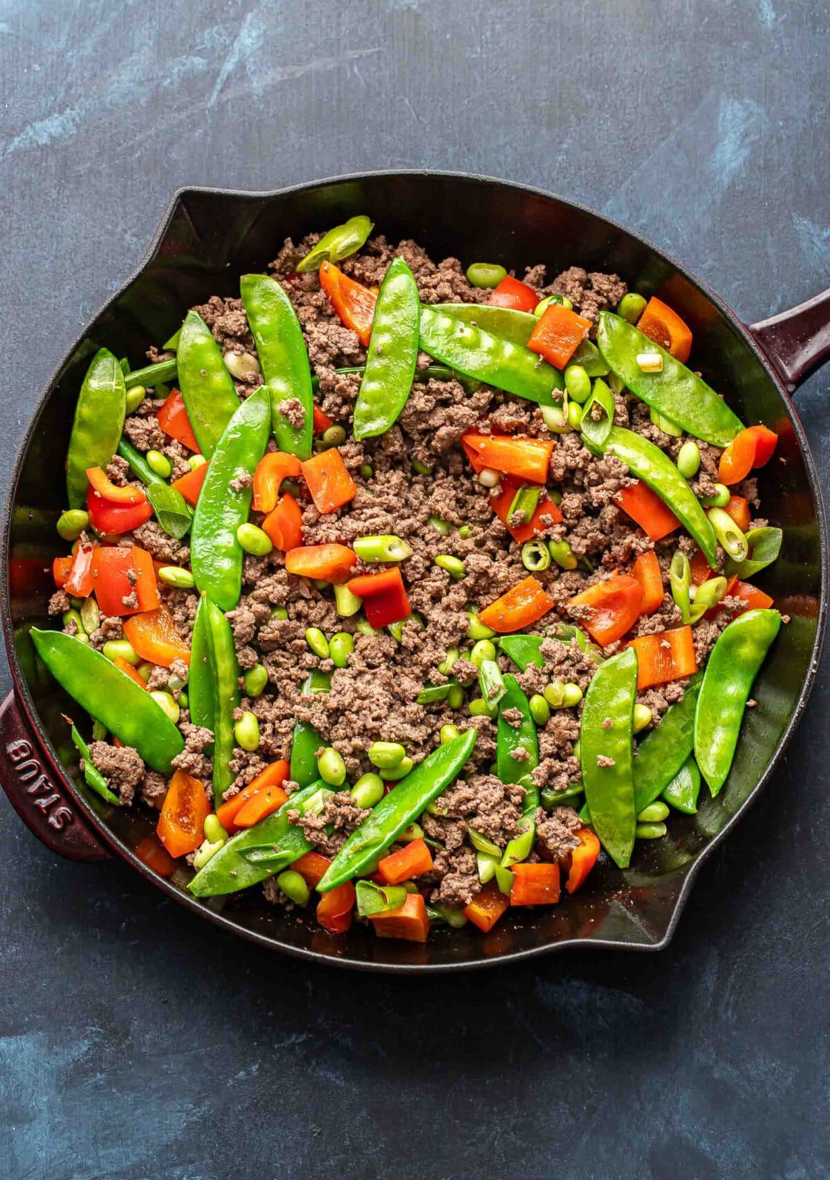 Ground beef and veggies in a skillet.