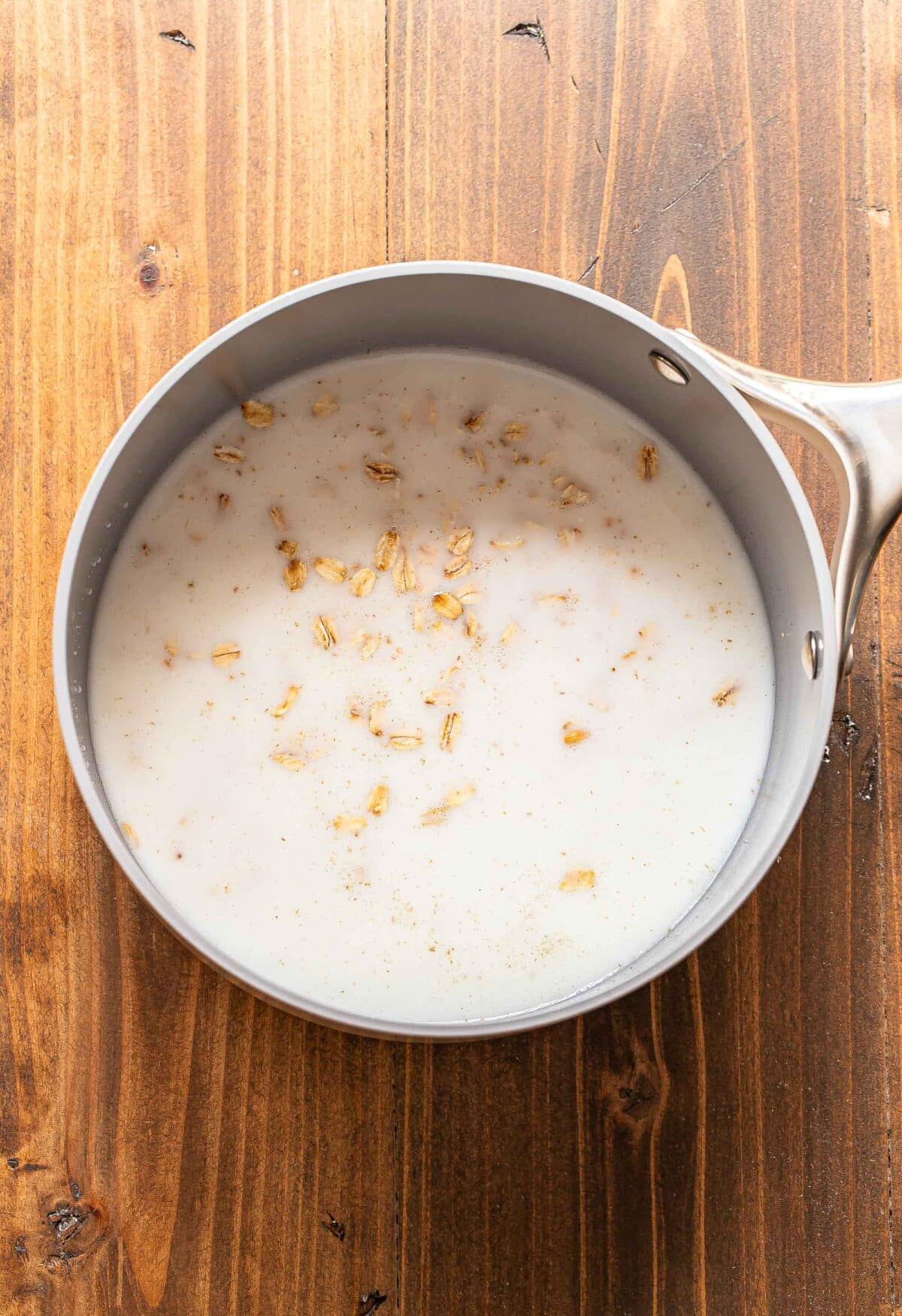Oats, milk, and water in a saucepan.