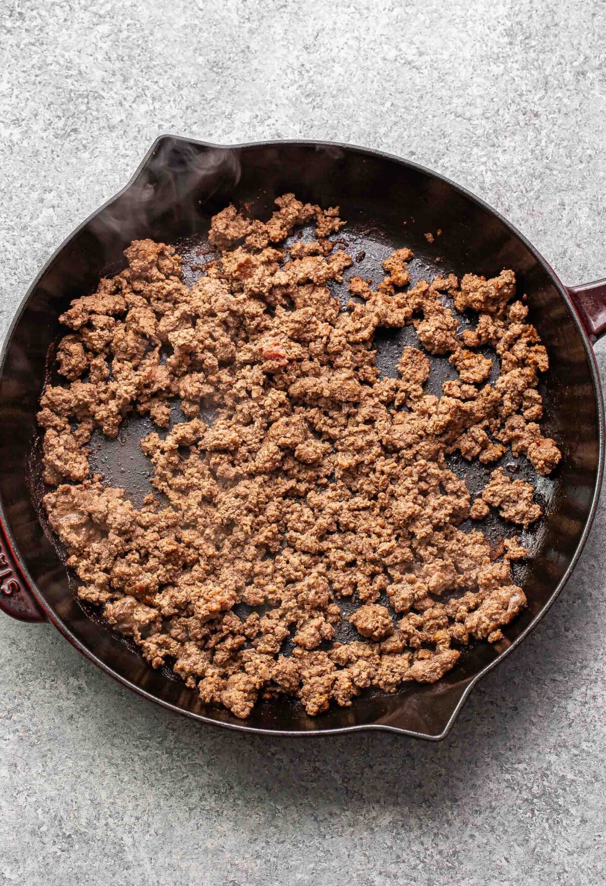 Cooked and crumbled ground beef in a skillet.