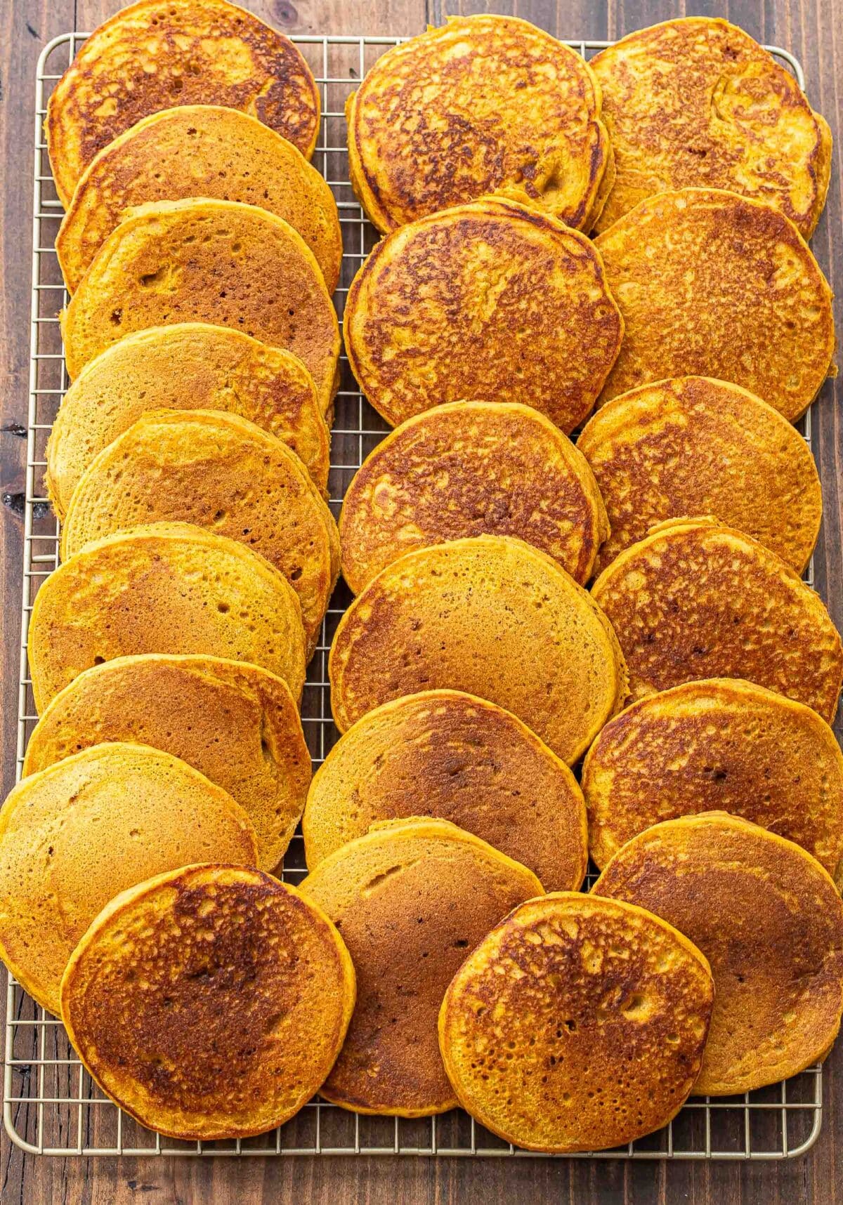 Pumpkin pancakes on a wire cooling rack.