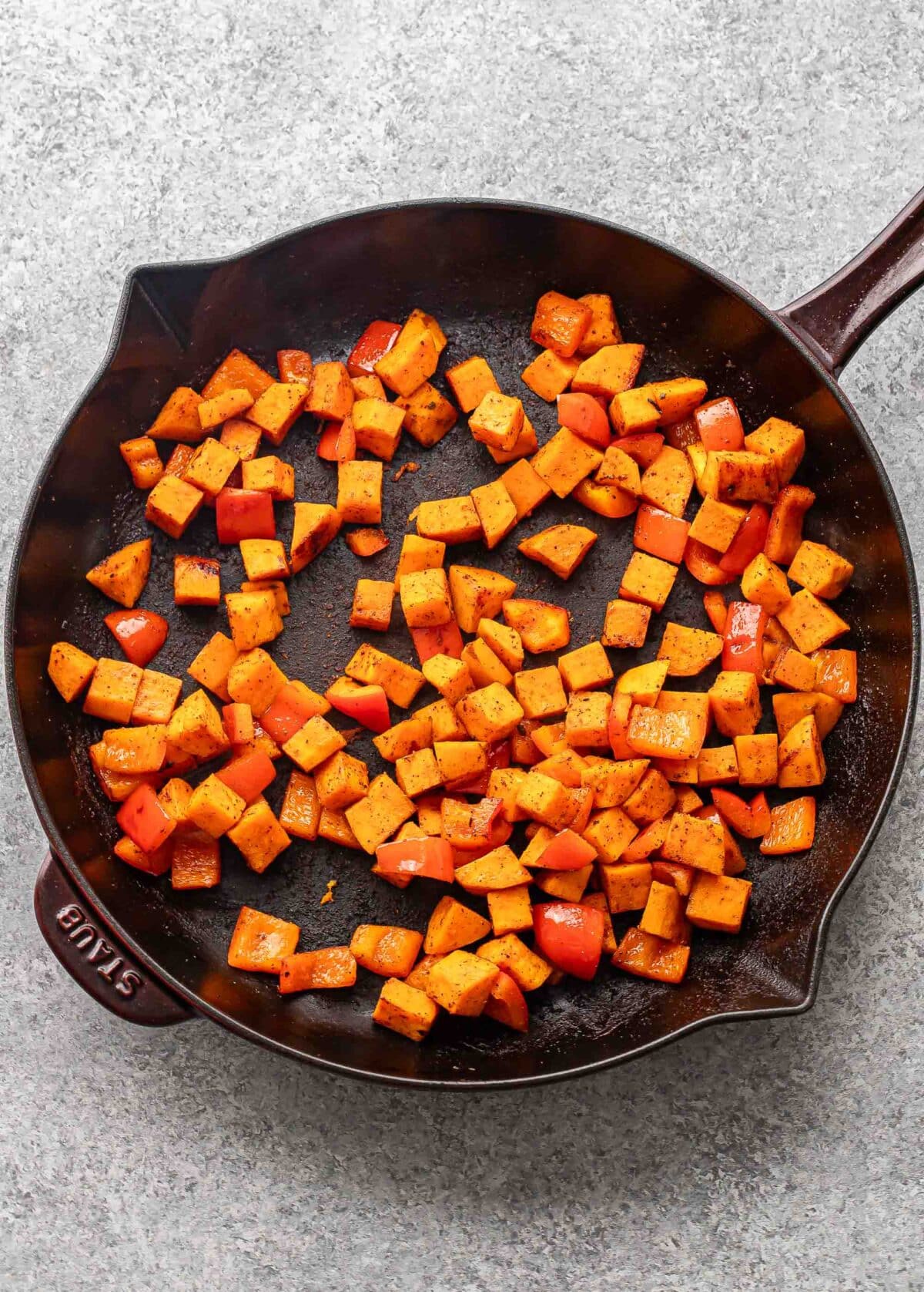 Diced sweet potato in a skillet.