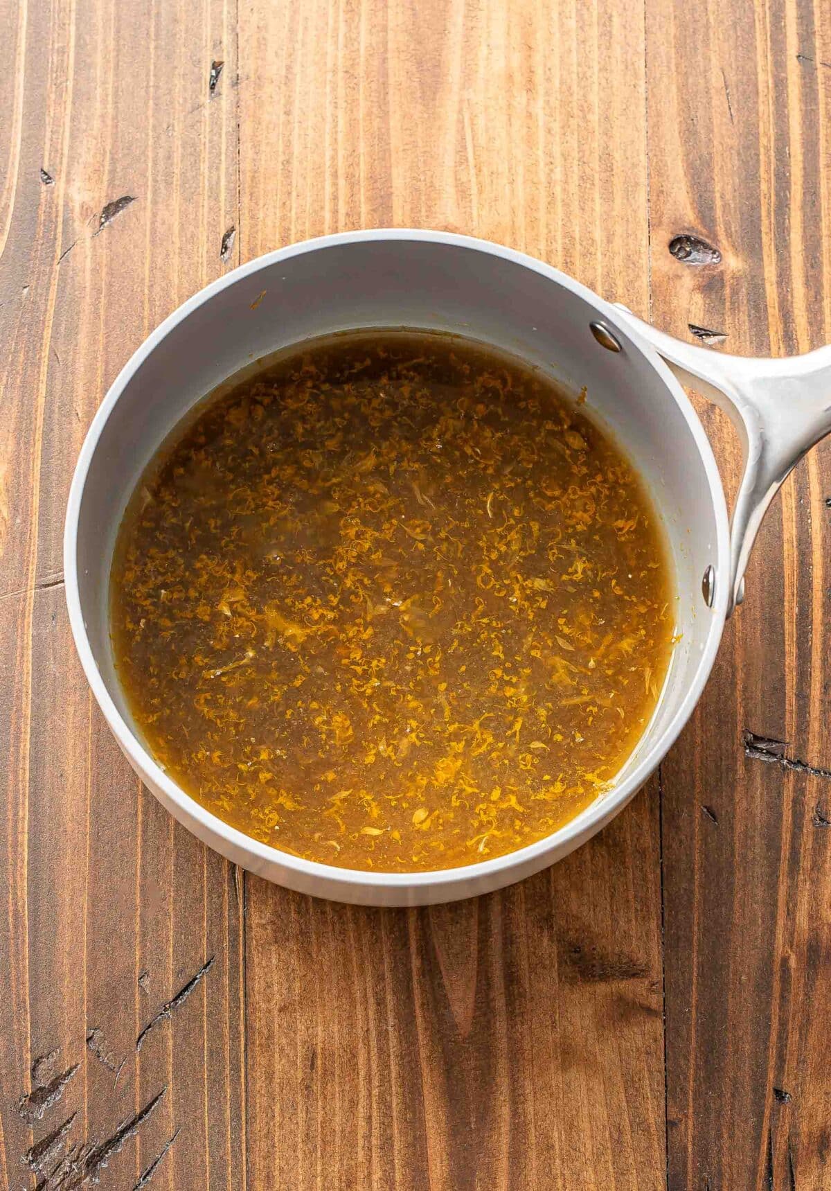 Brown sugar, orange zest and juice, and water in a saucepan.