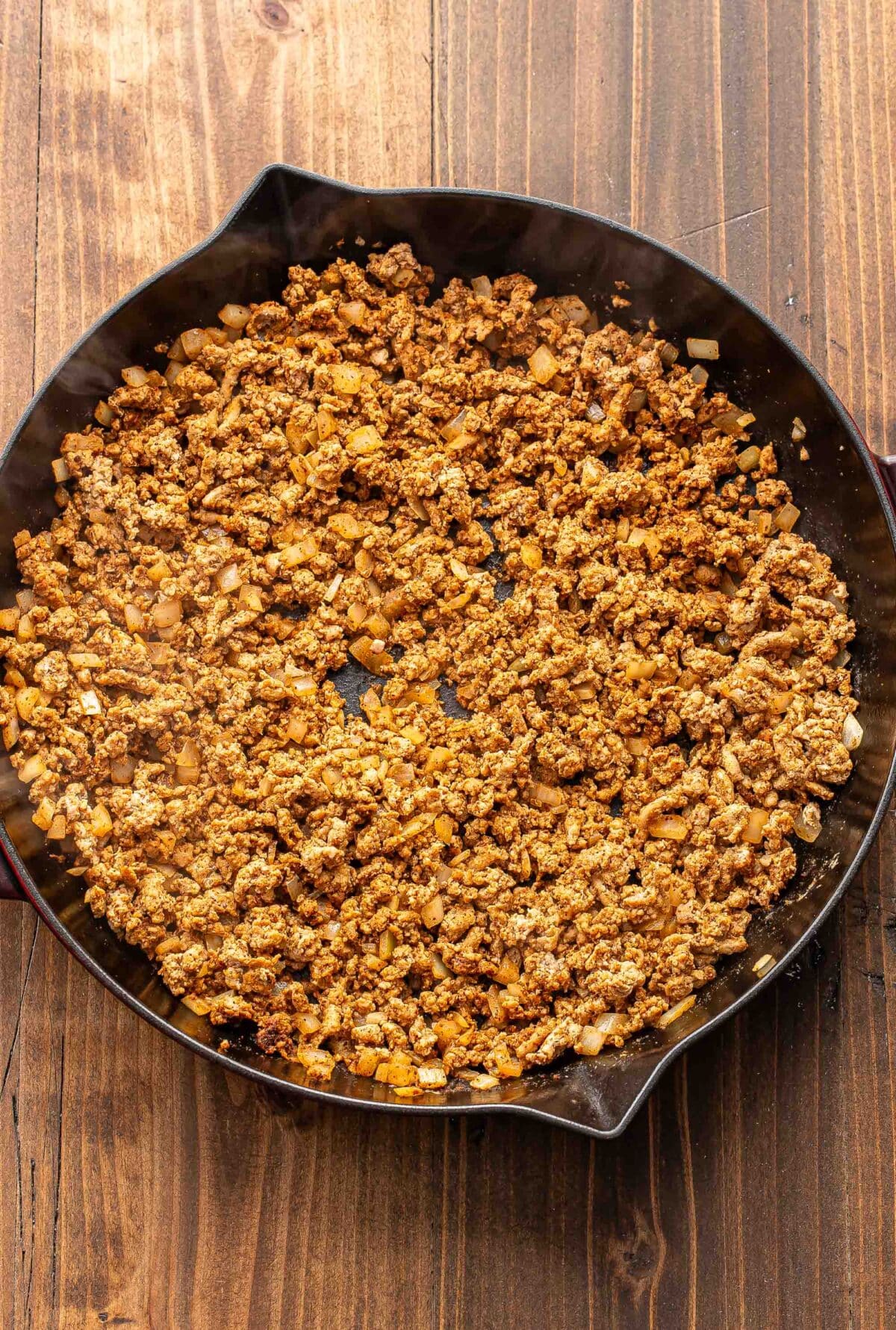 Cooked and crumbled ground turkey in a skillet.