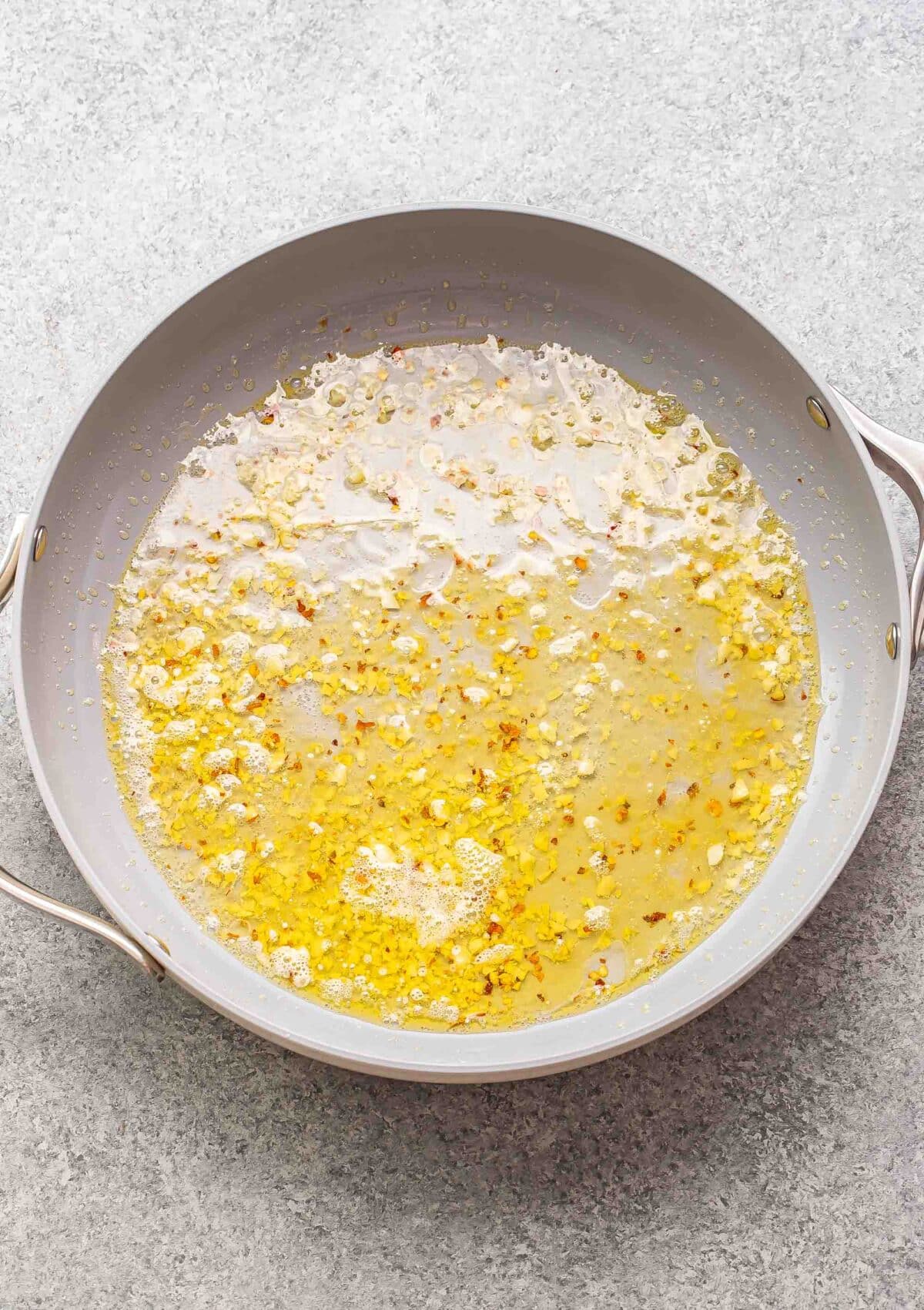 Butter, garlic, and white wine in a skillet.