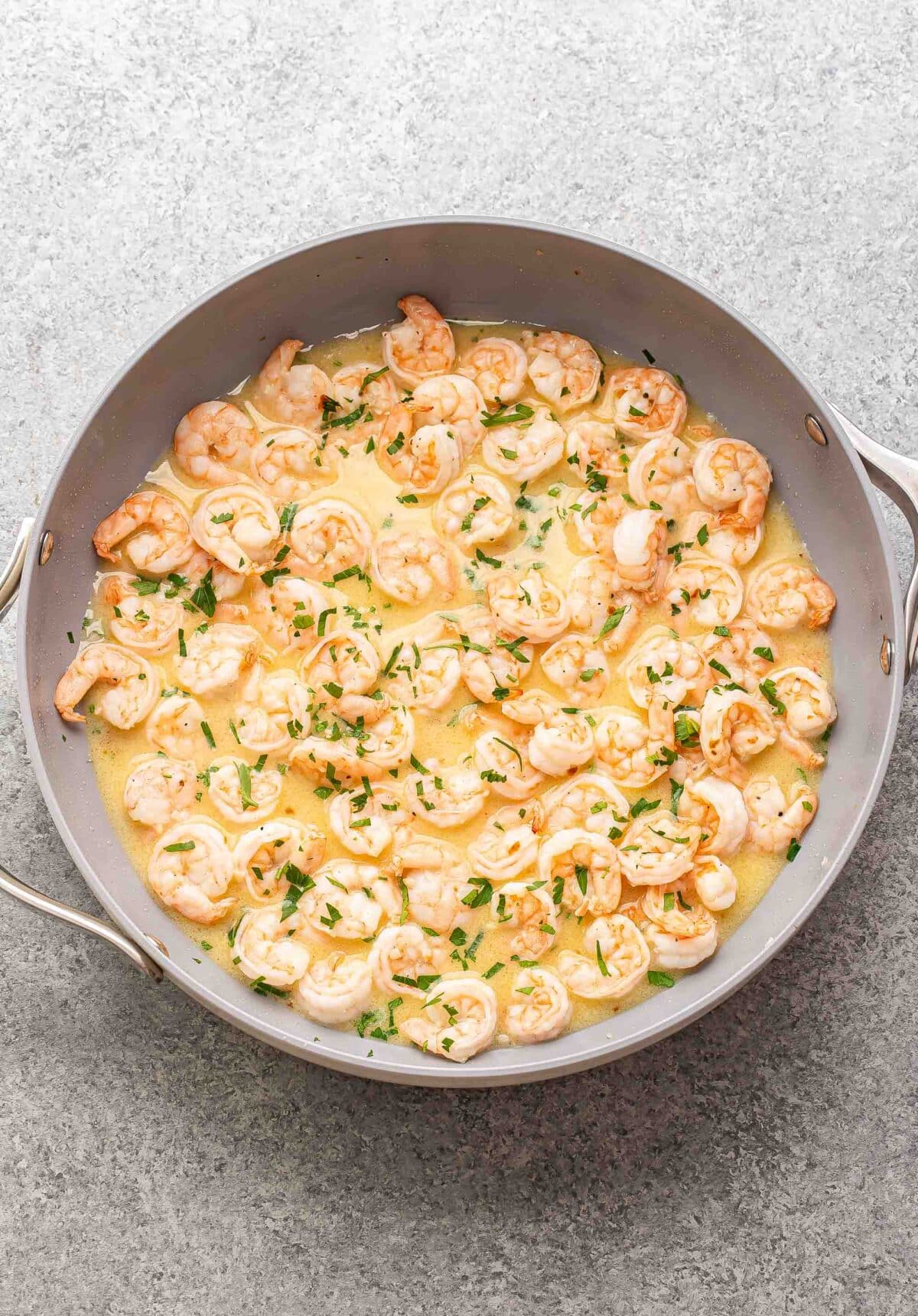 Shrimp scampi in a skillet.