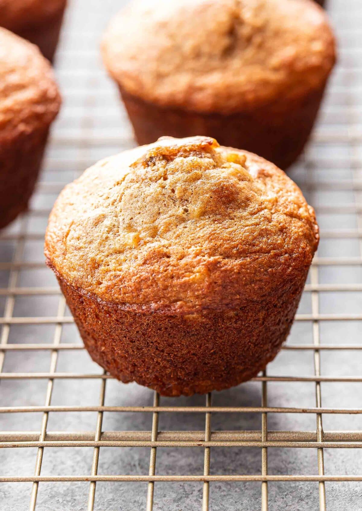 Banana muffin on a wire cooling rack.