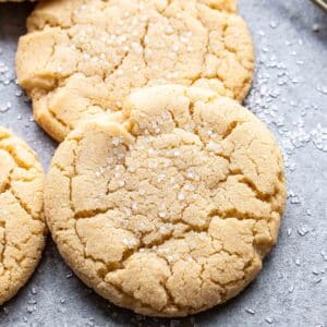 Two soft and chewy sugar cookies resting on each other.