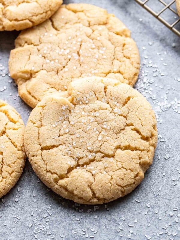 Two soft and chewy sugar cookies resting on each other.