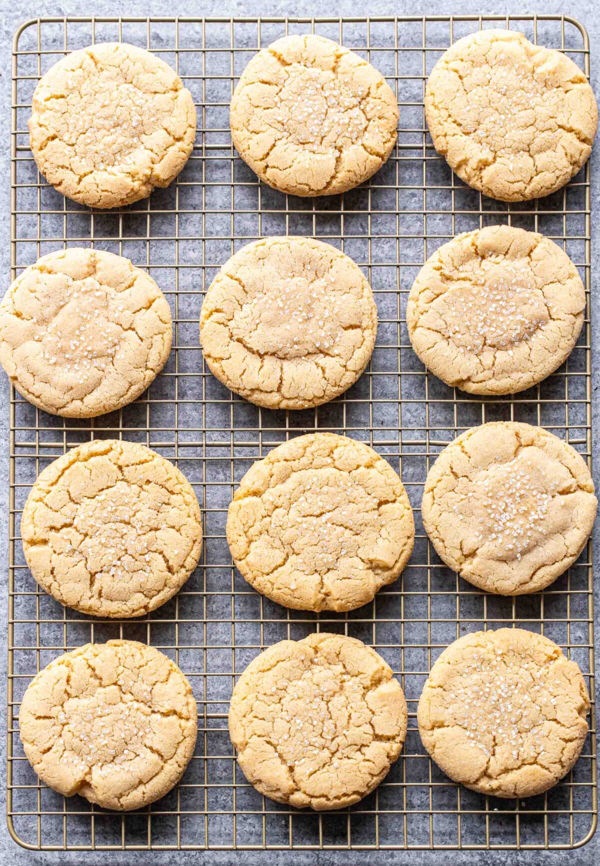 12 sugar cookies on a wire cooling rack.