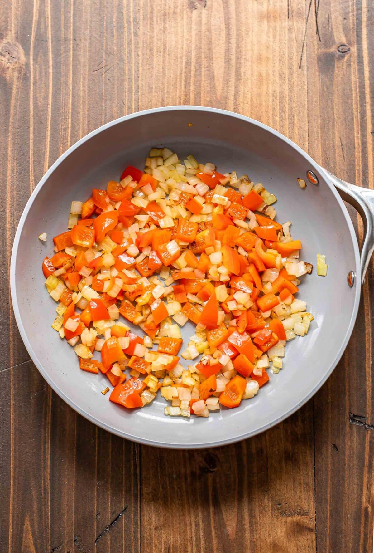 cooked peppers and onions in a skillet.