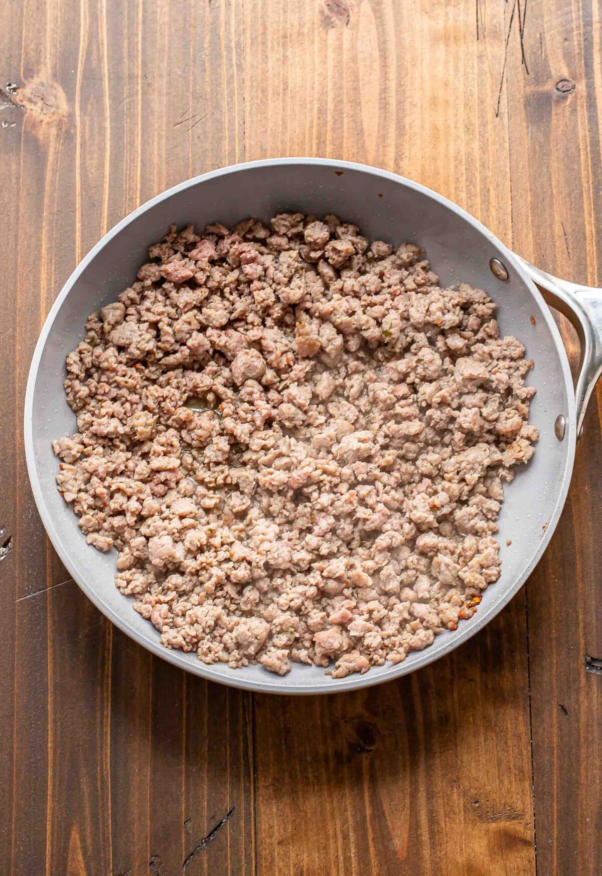 Crumbled breakfast sausage in a skillet.