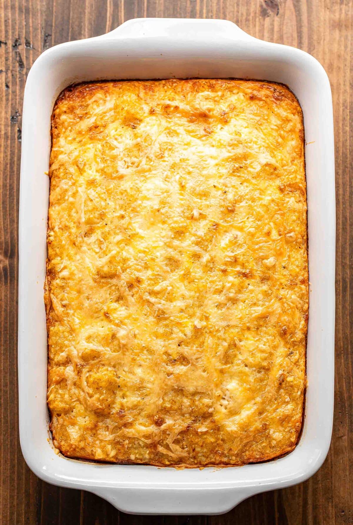 Tater tot breakfast casserole in a white casserole dish.