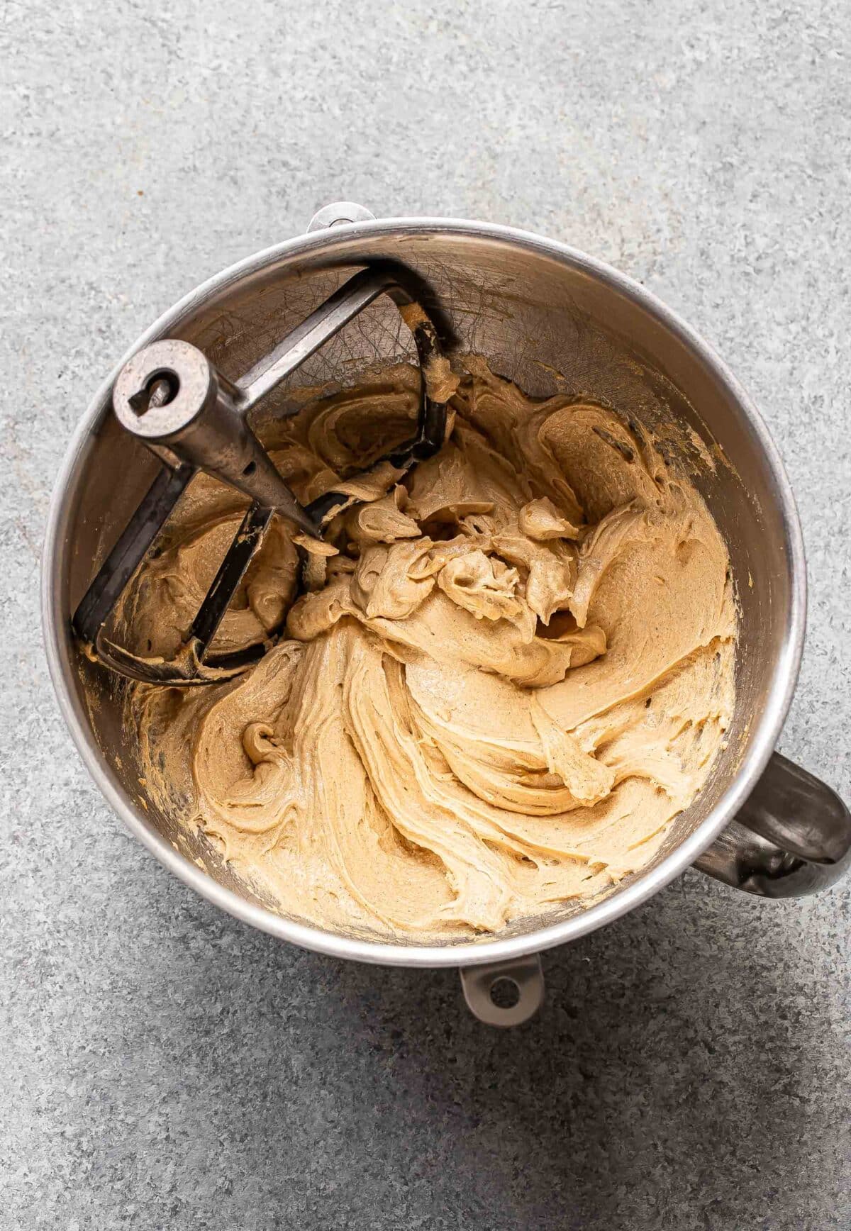 Wet ingredients for chocolate chip cookie dough beaten together in a mixing bowl.