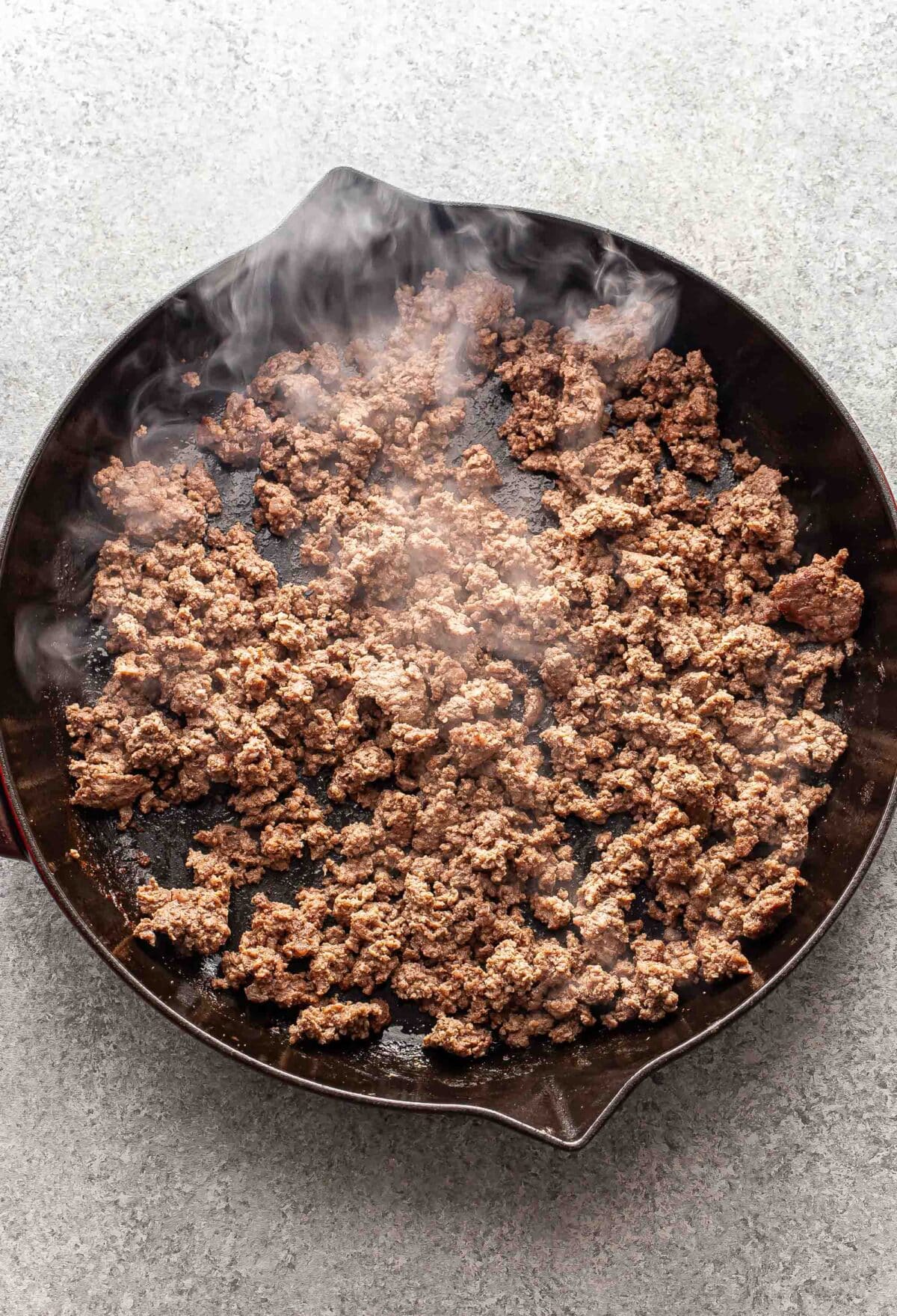 Cooked ground beef in a skillet.