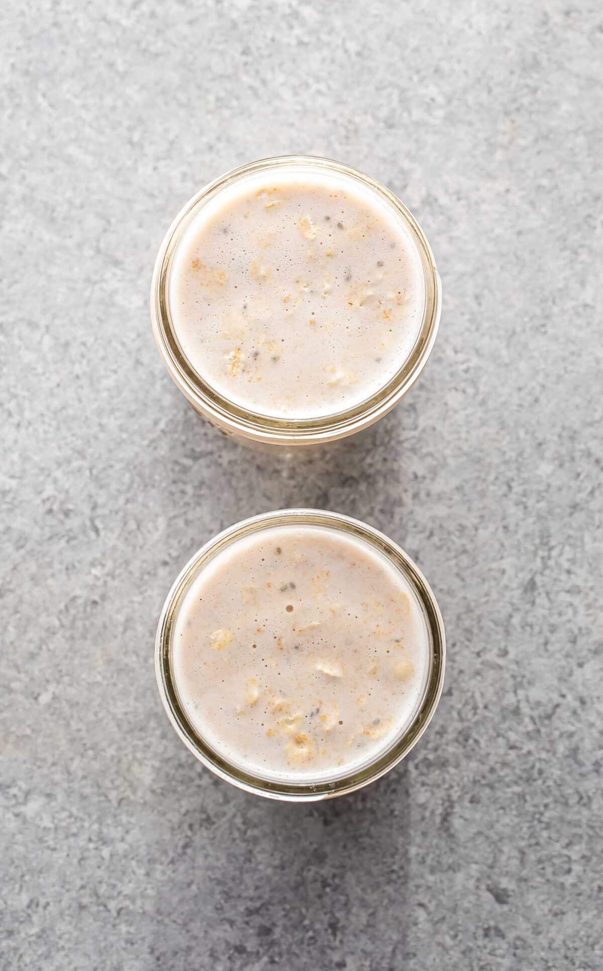 Peanut butter overnight oats in two glass jars.