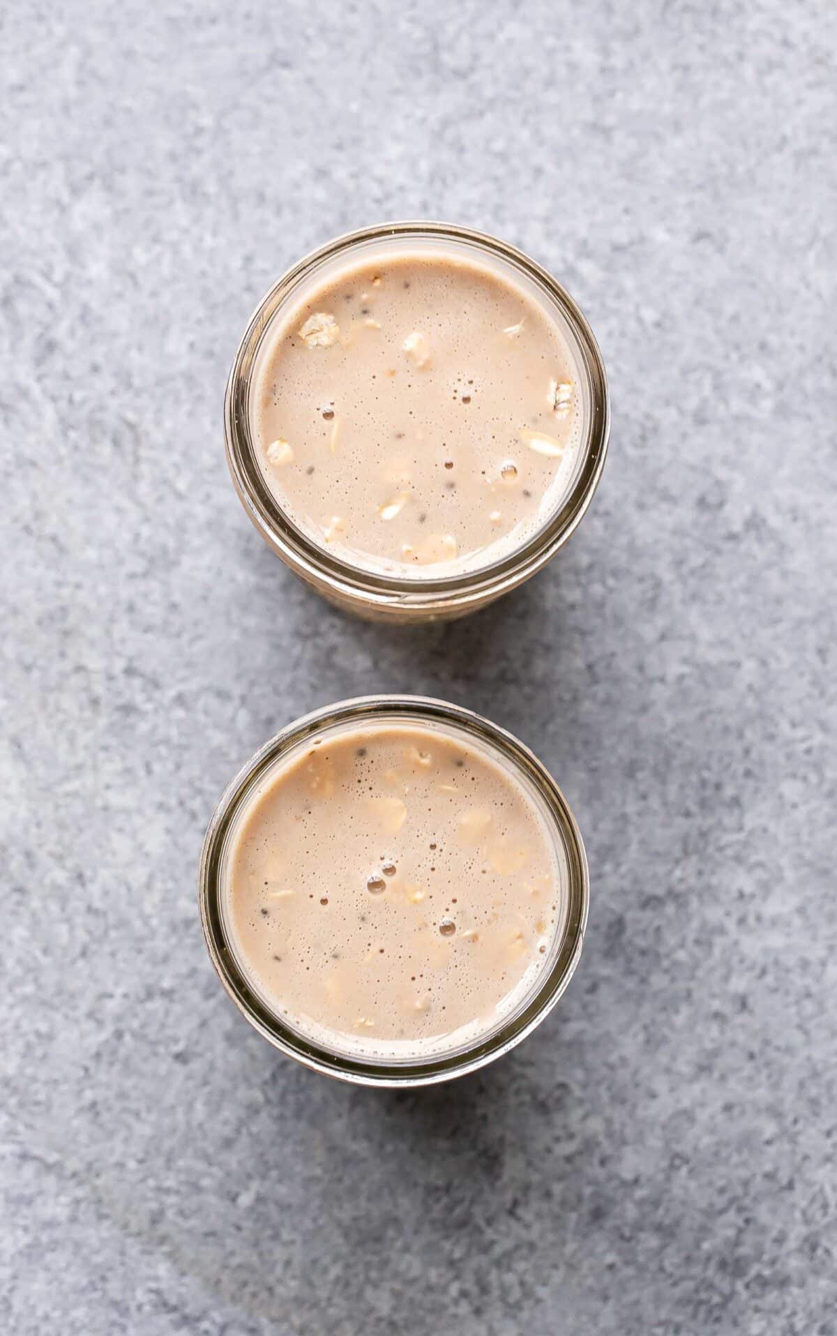 Coffee overnight oats in a two glass jars.