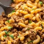 Hamburger helper in a white bowl with a fork.