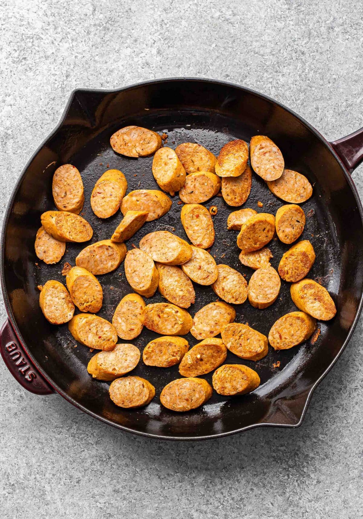 Sliced sausage in a skillet.