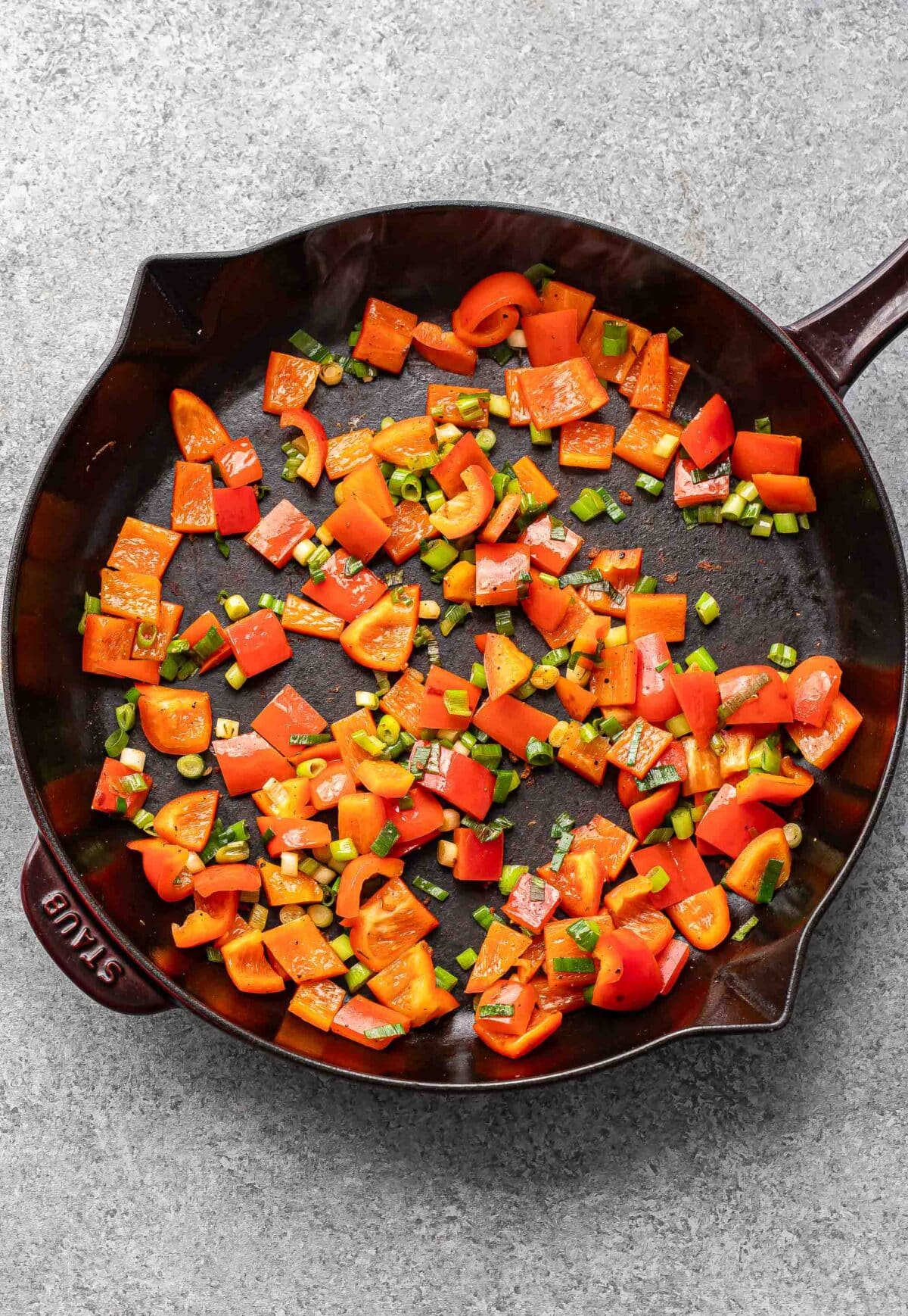 Peppers and onions in a skillet.