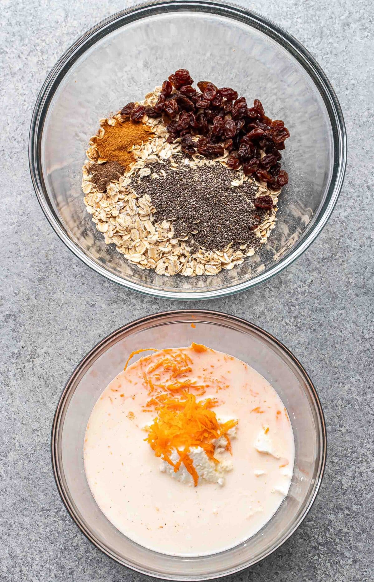 Wet ingredients for carrot cake overnight oats in a small glass bowl. Oats, raisins, and spices in a bigger glass bowl.