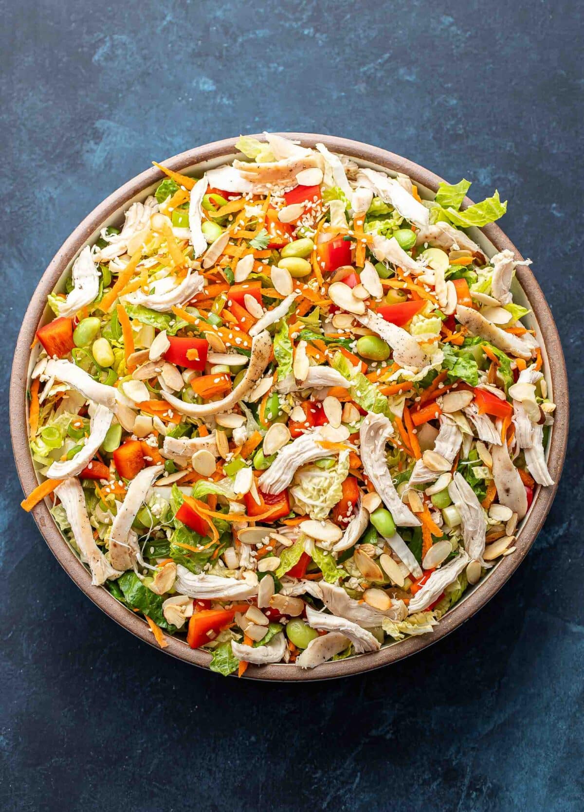 Chinese chicken salad in a white salad bowl.