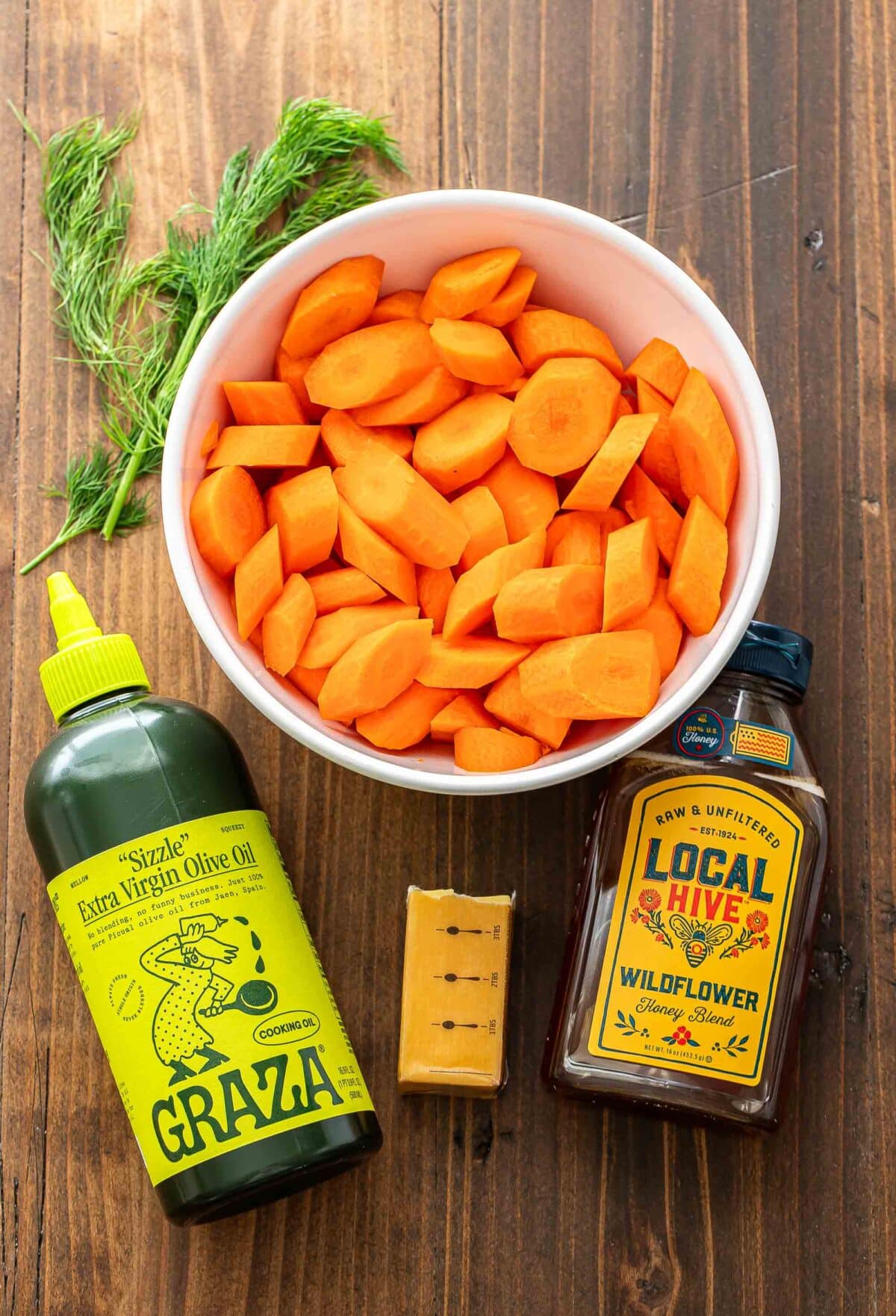 Ingredients used to make roasted carrots with honey butter and dill.