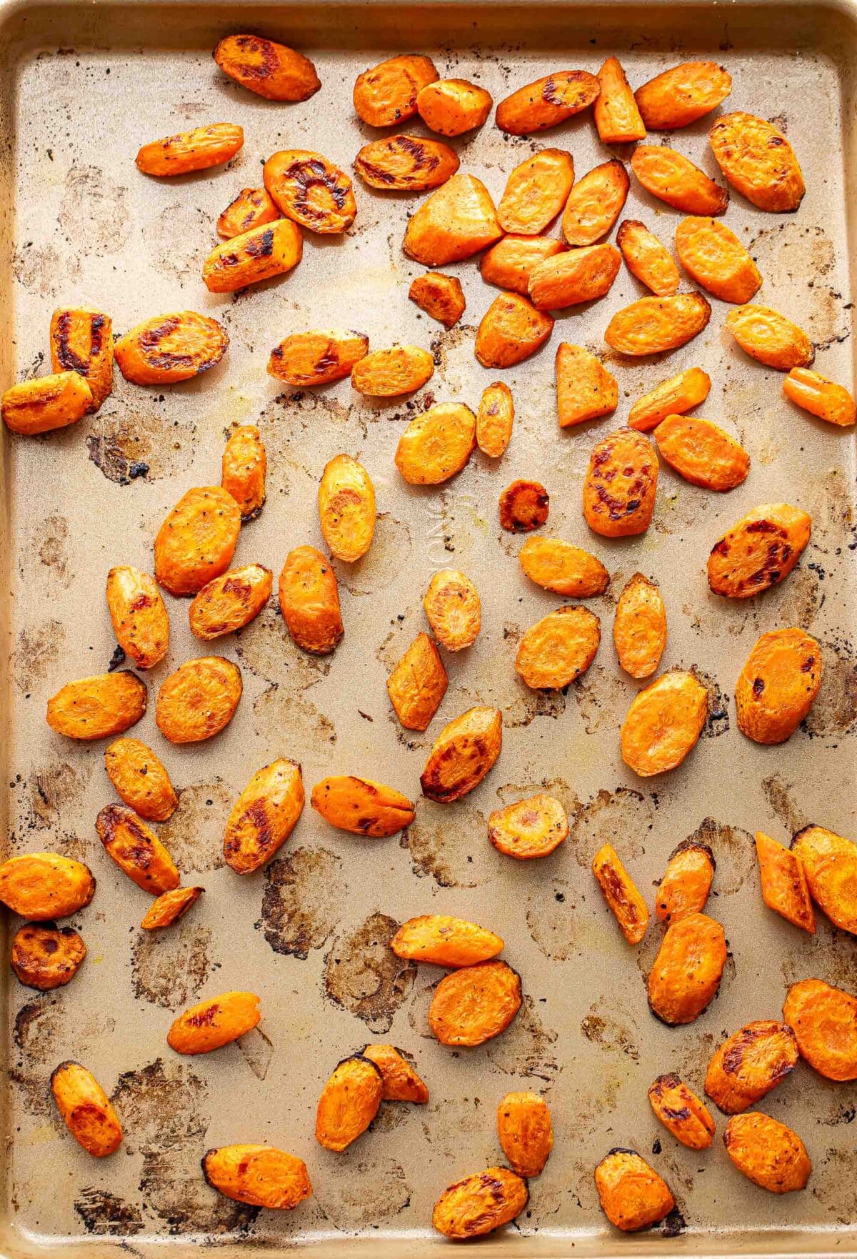 Roasted carrot chunks on a baking sheet.