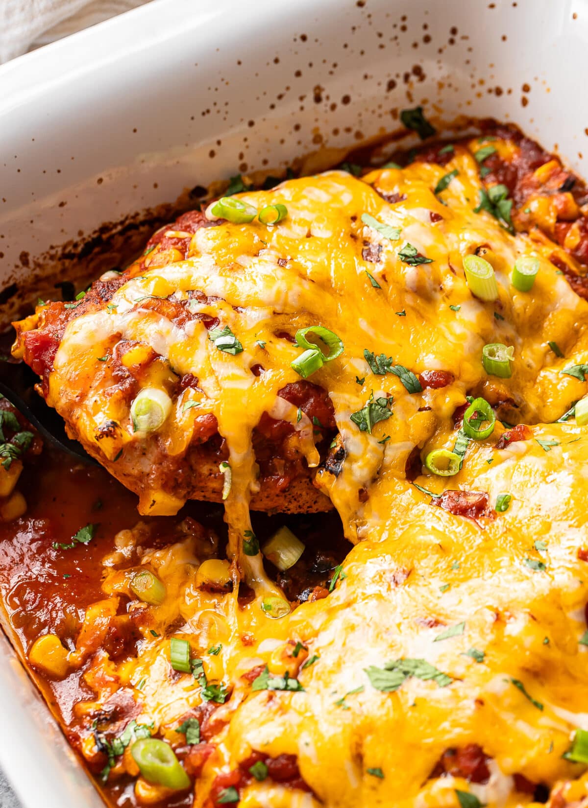 Baked chicken breast topped with salsa and melted cheese.