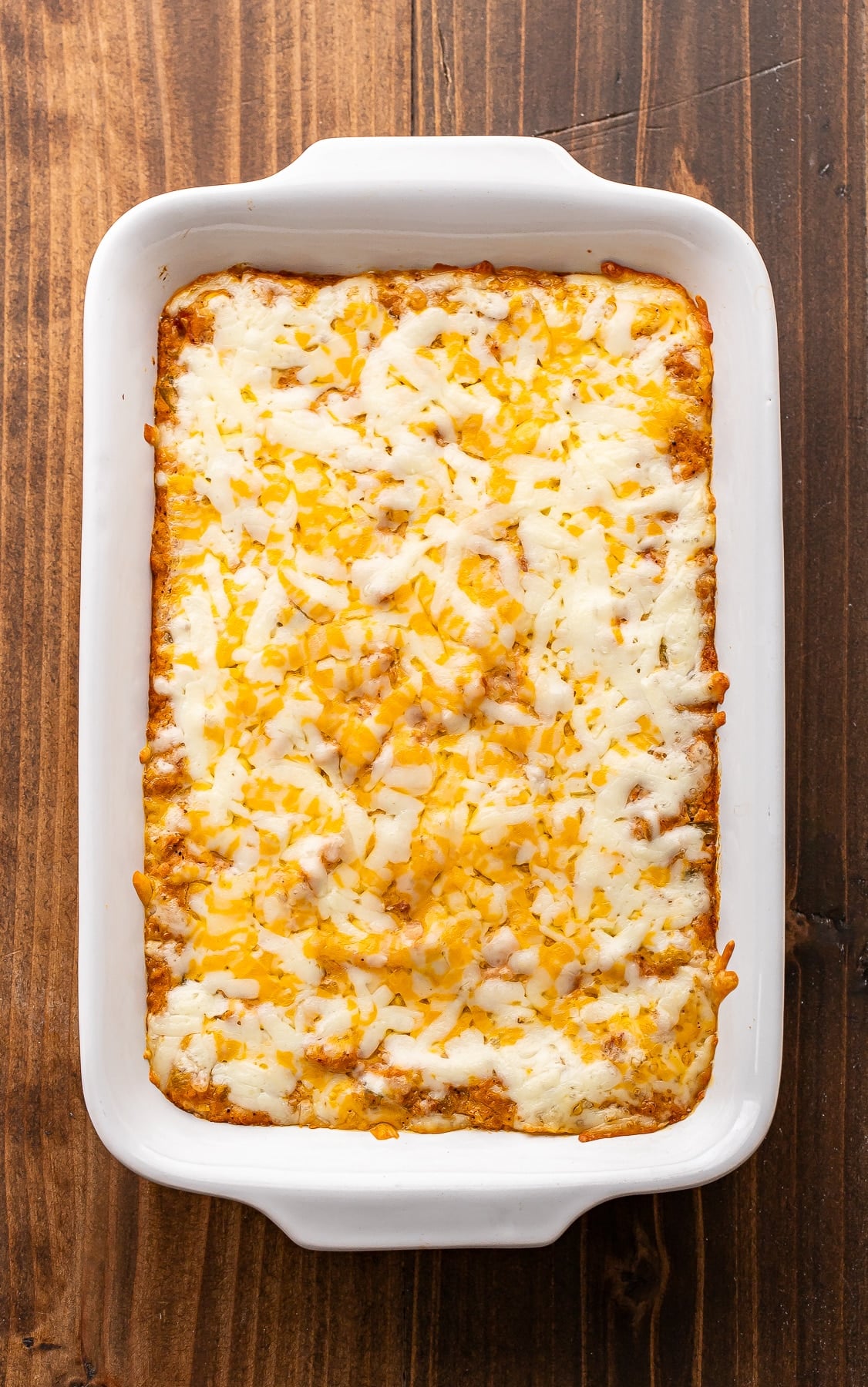 Cheesy baked bean dip in a white rectangular baking dish.
