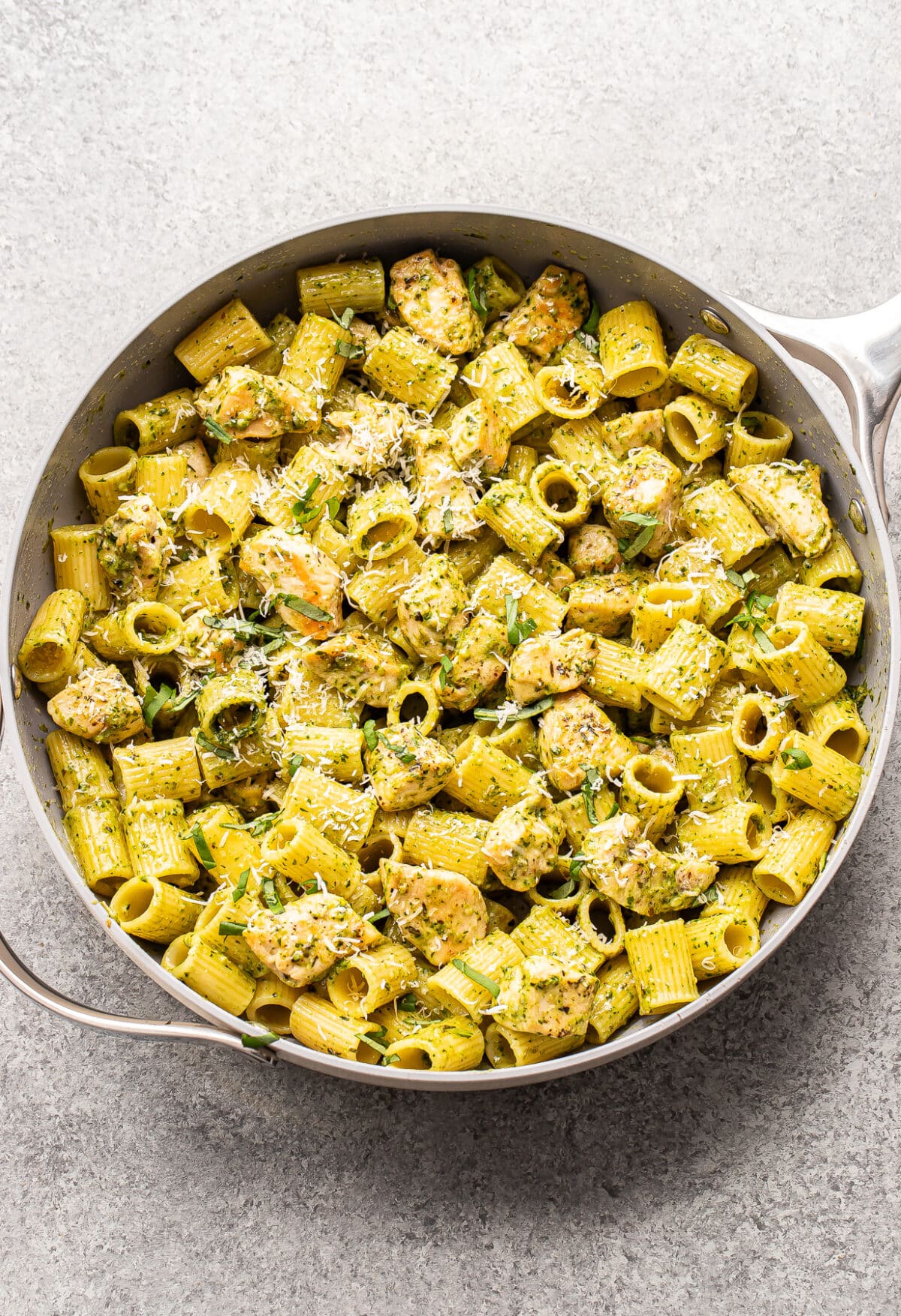 Creamy pesto chicken pasta in a skillet.