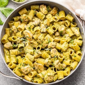 Pesto chicken pasta in a skillet.