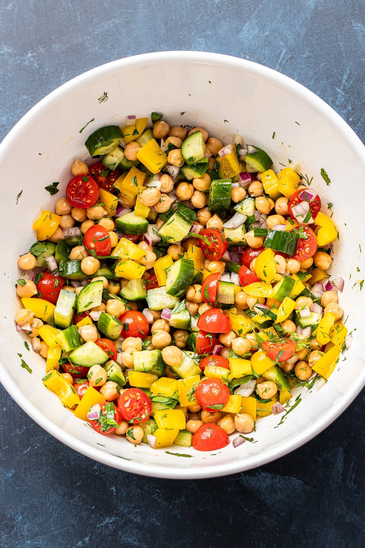 Chickpea salad in a white mixing bowl.