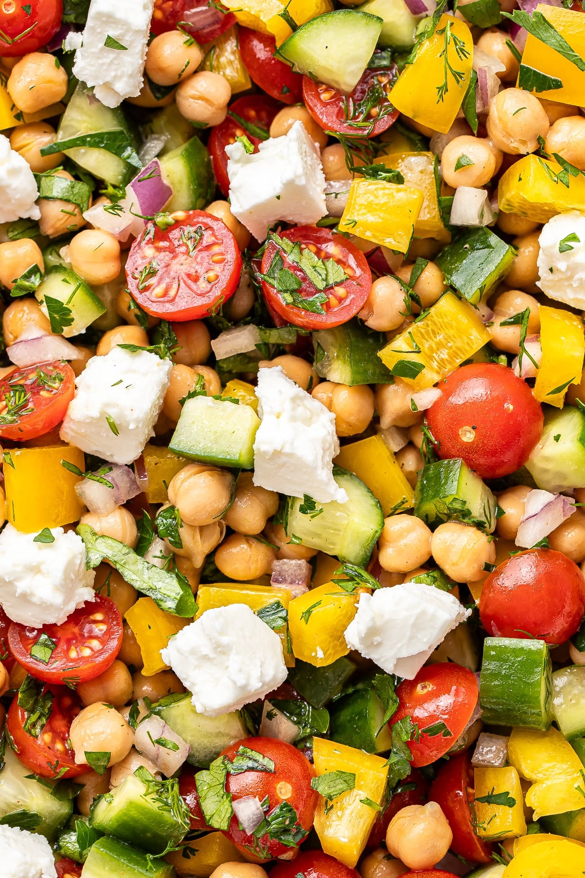 Chickpeas, feta, tomatoes, cucumbers, yellow bell peppers, and harbs.