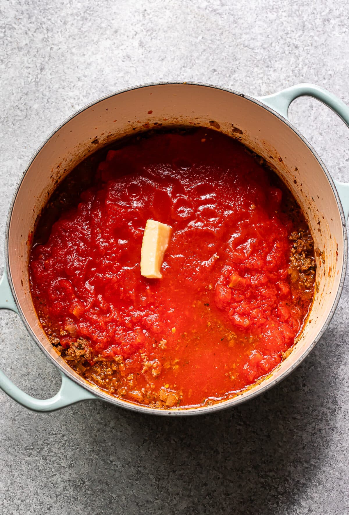 Spaghetti meat sauce ingredients in a pot before it's been cooked.