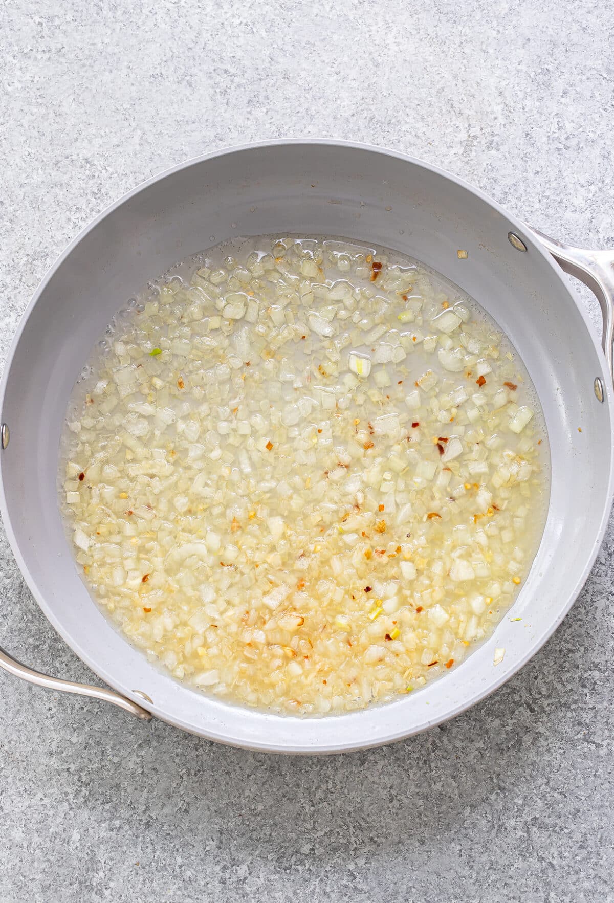 onions, garlic, red pepper flakes, and vodka in a skillet.